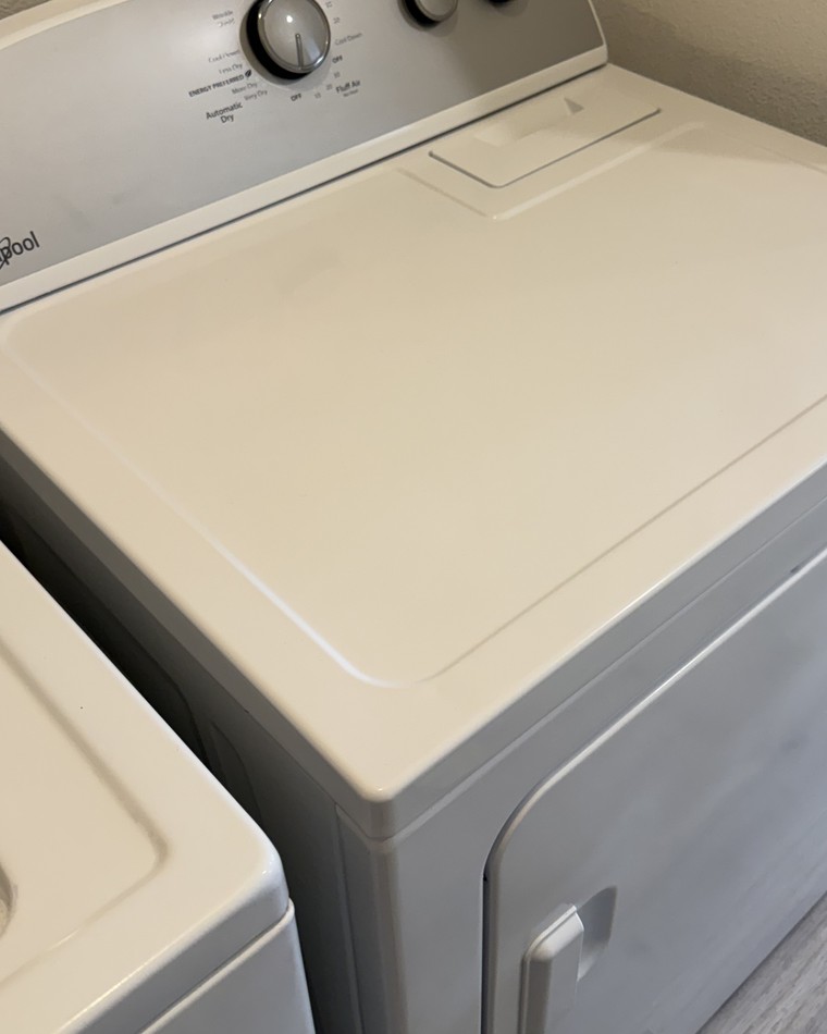 The same dryer top after cleaning, wiped down and free of lint and marks
