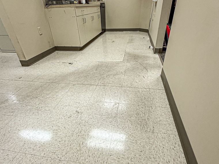 Break room tile floor before stripping, dull and heavily scuffed