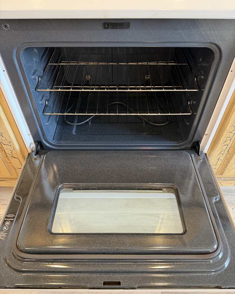 The same oven after cleaning, with the enamel, racks and door glass clear