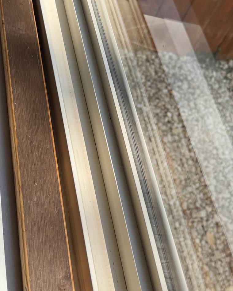 The same door track after cleaning, with the channel and rails clear
